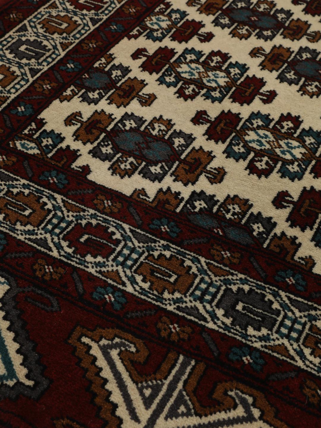 Hand-knotted Middle Eastern Turkaman wool rug in red and beige