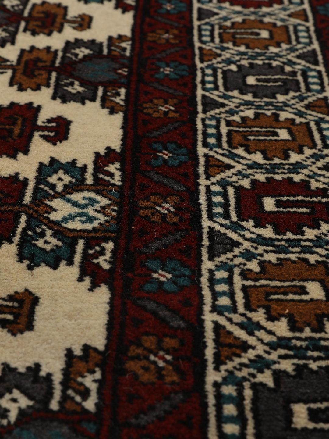 Hand-knotted Middle Eastern Turkaman wool rug in red and beige