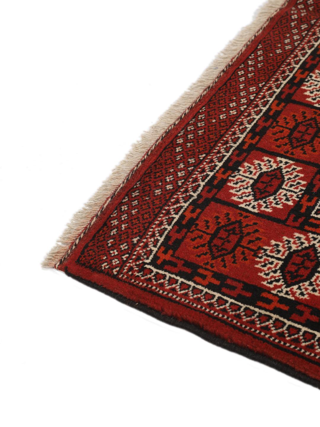 Hand-knotted Turkaman rug from the Middle East featuring an amber field and dark red border.