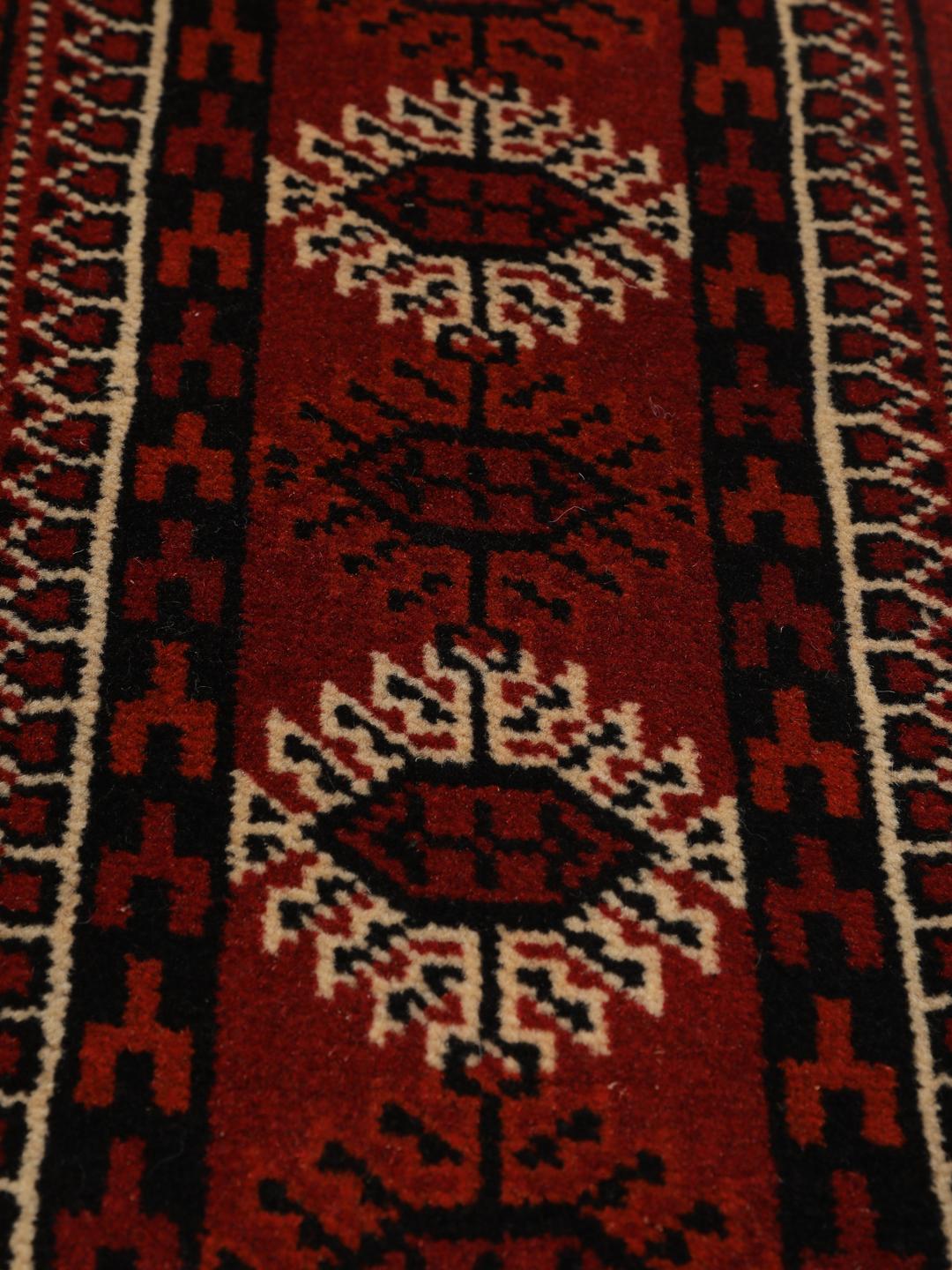 Hand-knotted Turkaman rug from the Middle East featuring an amber field and dark red border.
