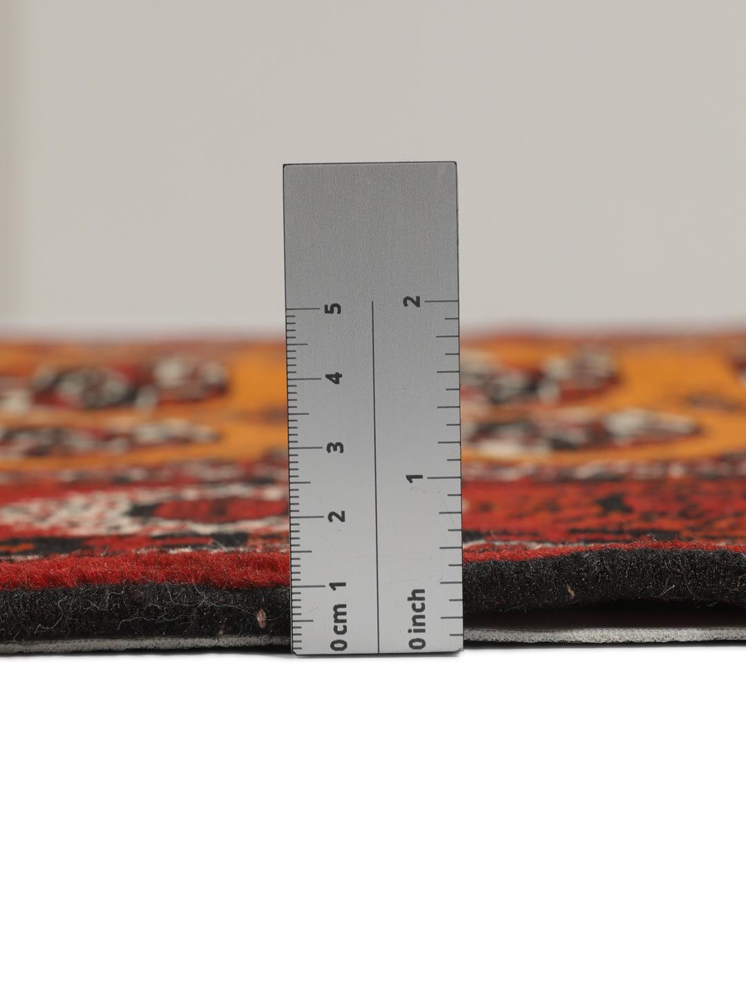 Hand-knotted Turkaman rug from the Middle East featuring an amber field and dark red border.
