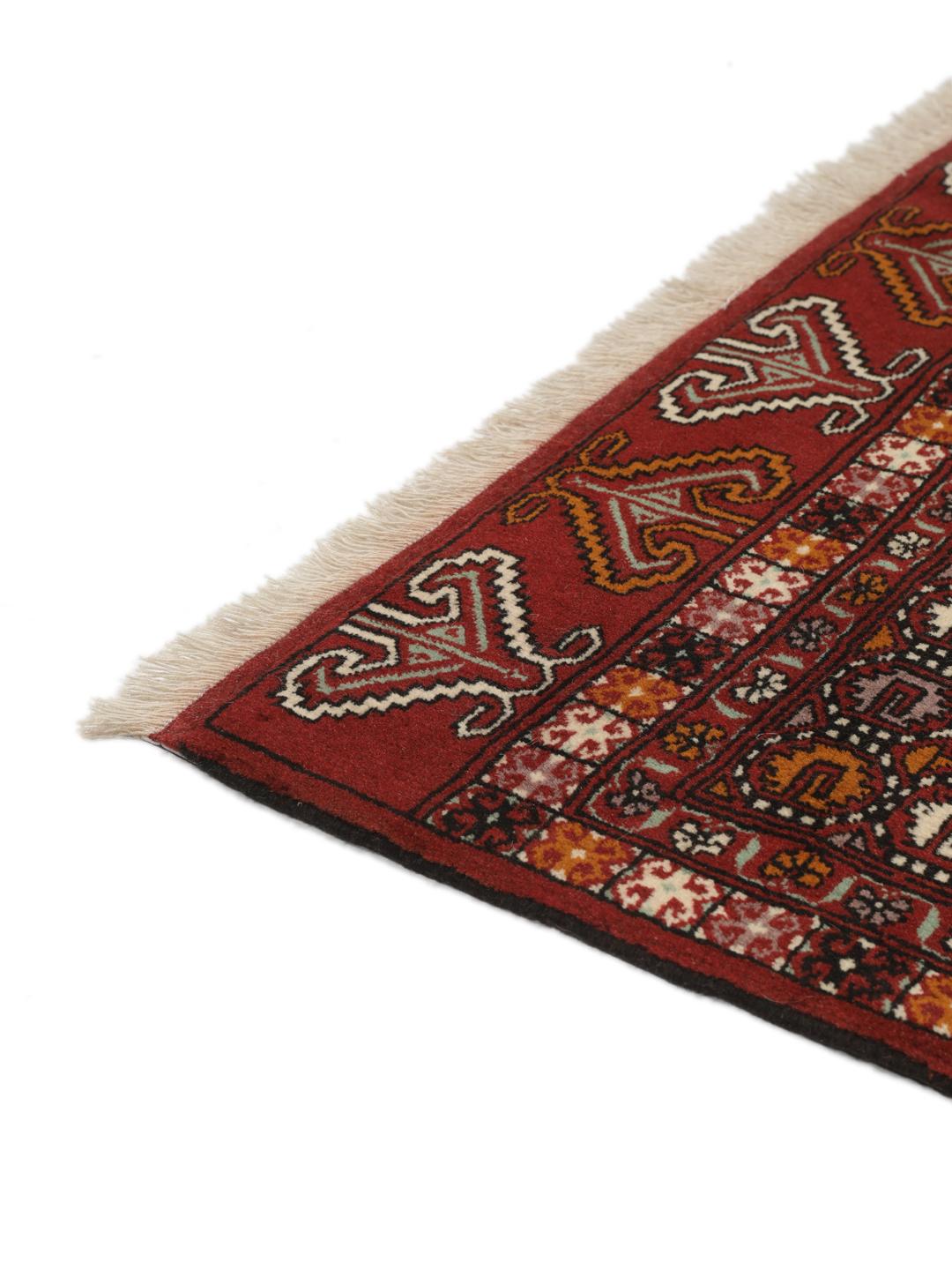 Hand-knotted Turkaman Wool rug from the Middle East in deep red and beige tones