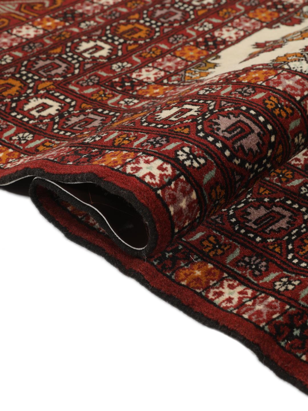 Hand-knotted Turkaman Wool rug from the Middle East in deep red and beige tones