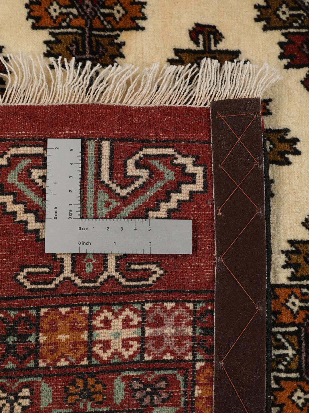 Hand-knotted Turkaman Wool rug from the Middle East in deep red and beige tones