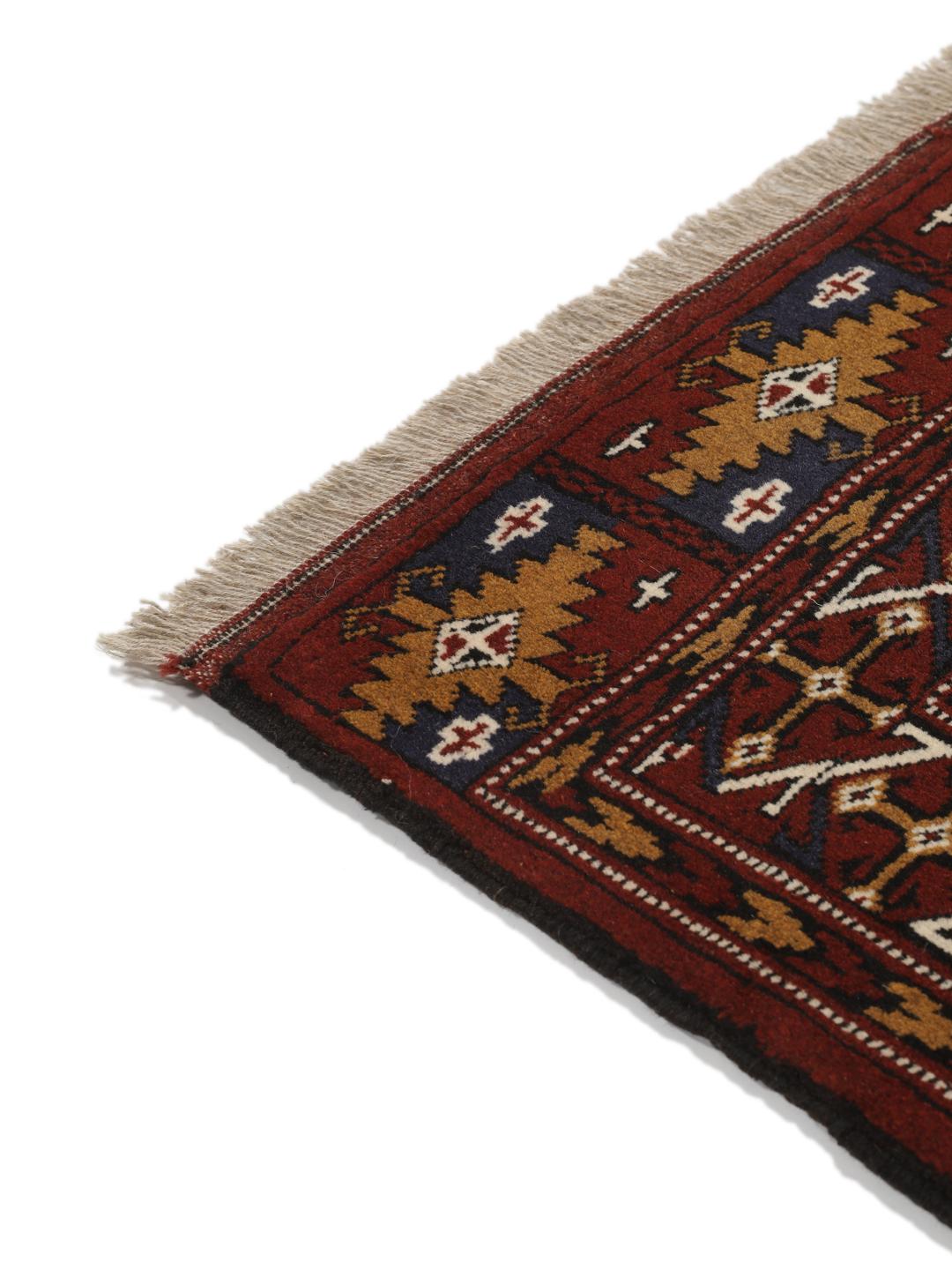 Hand-knotted Turkaman rug from the Middle East in deep red and beige tones