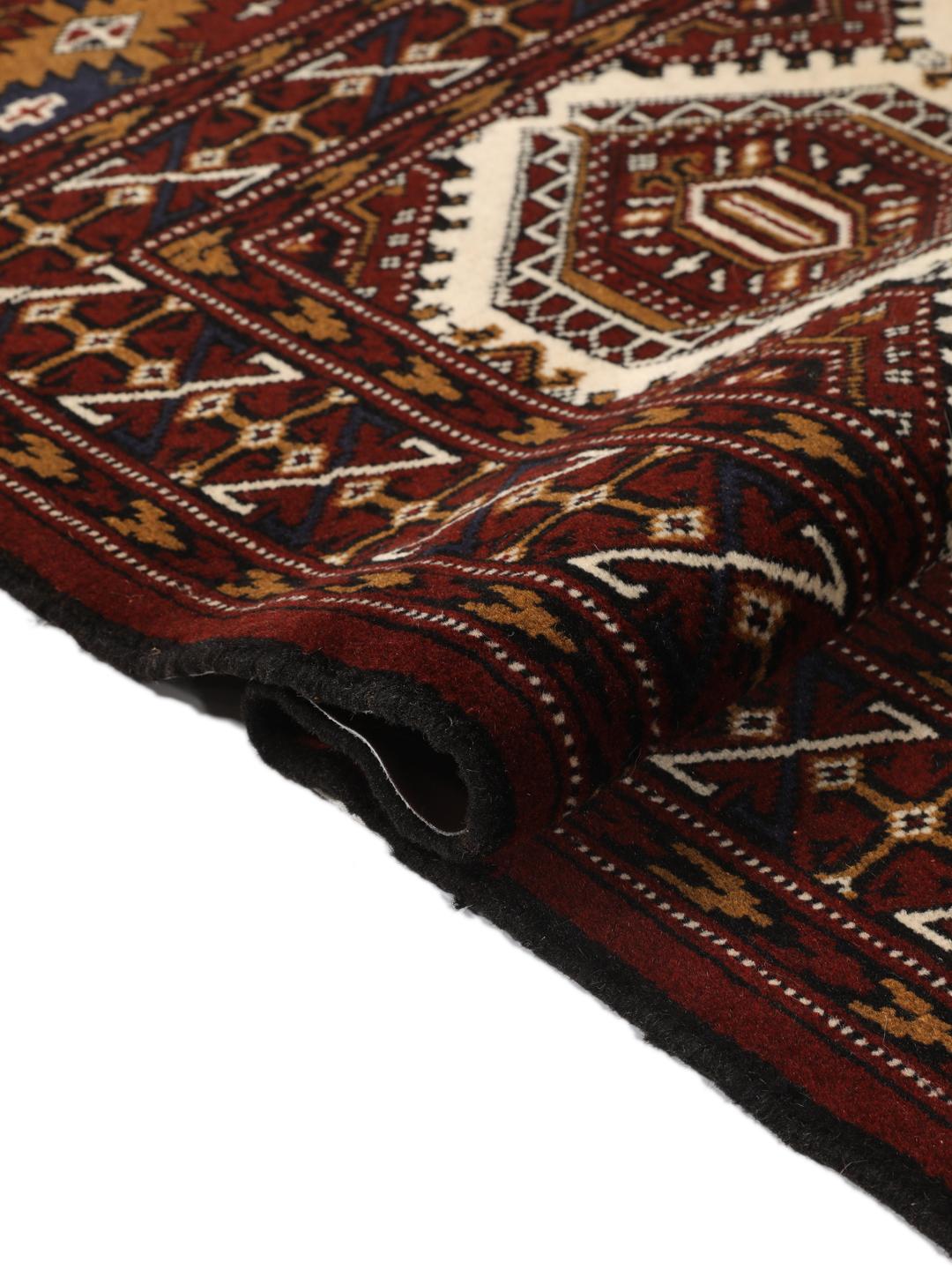Hand-knotted Turkaman rug from the Middle East in deep red and beige tones