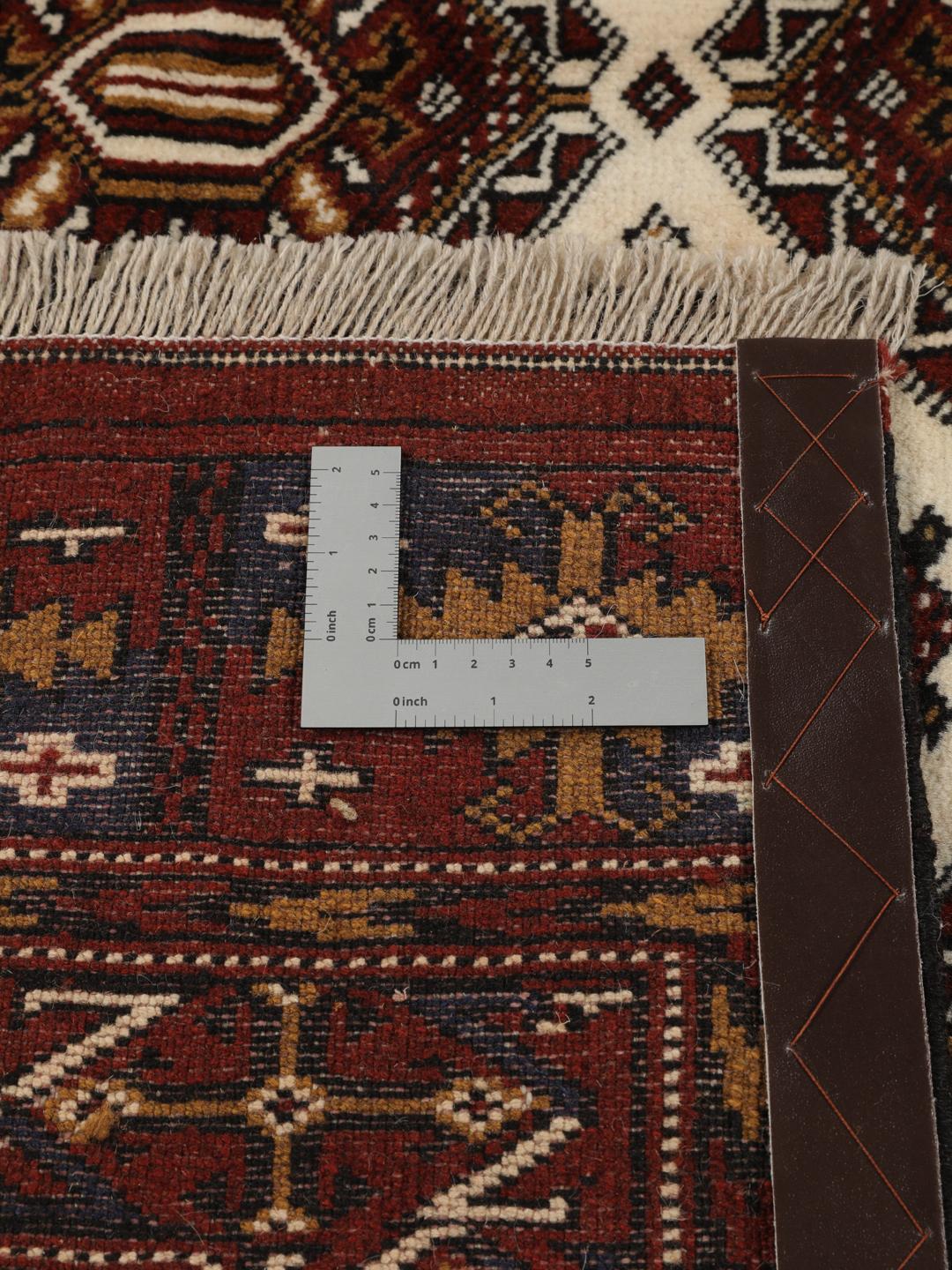 Hand-knotted Turkaman rug from the Middle East in deep red and beige tones