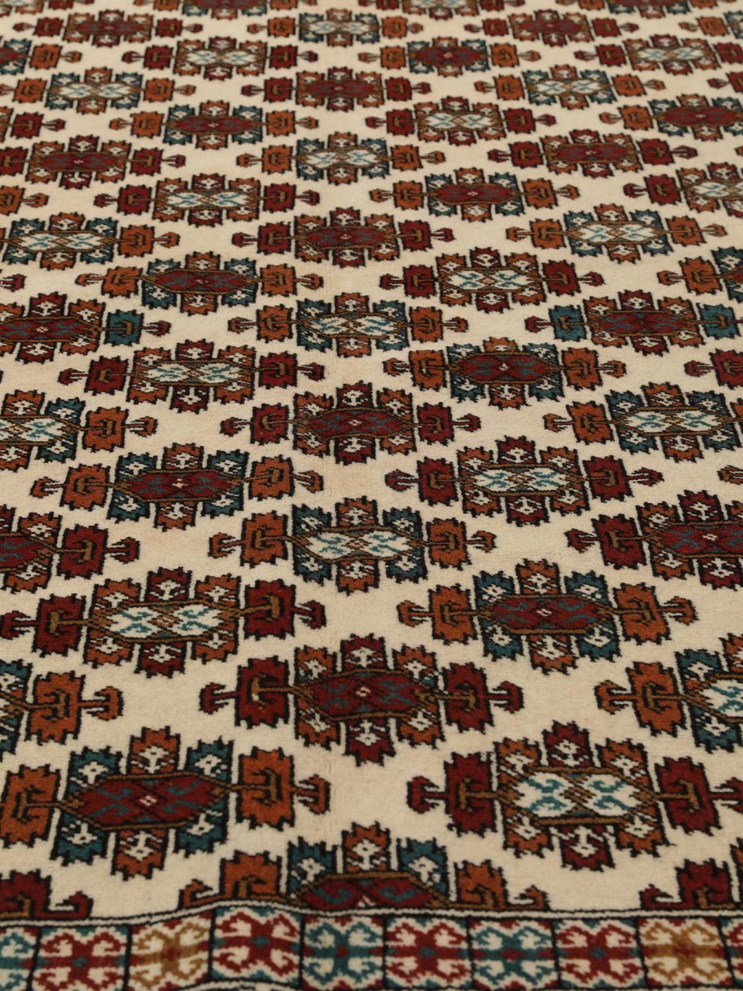 Hand-knotted Turkaman rug from the Middle East in beige with repeating geometric motifs