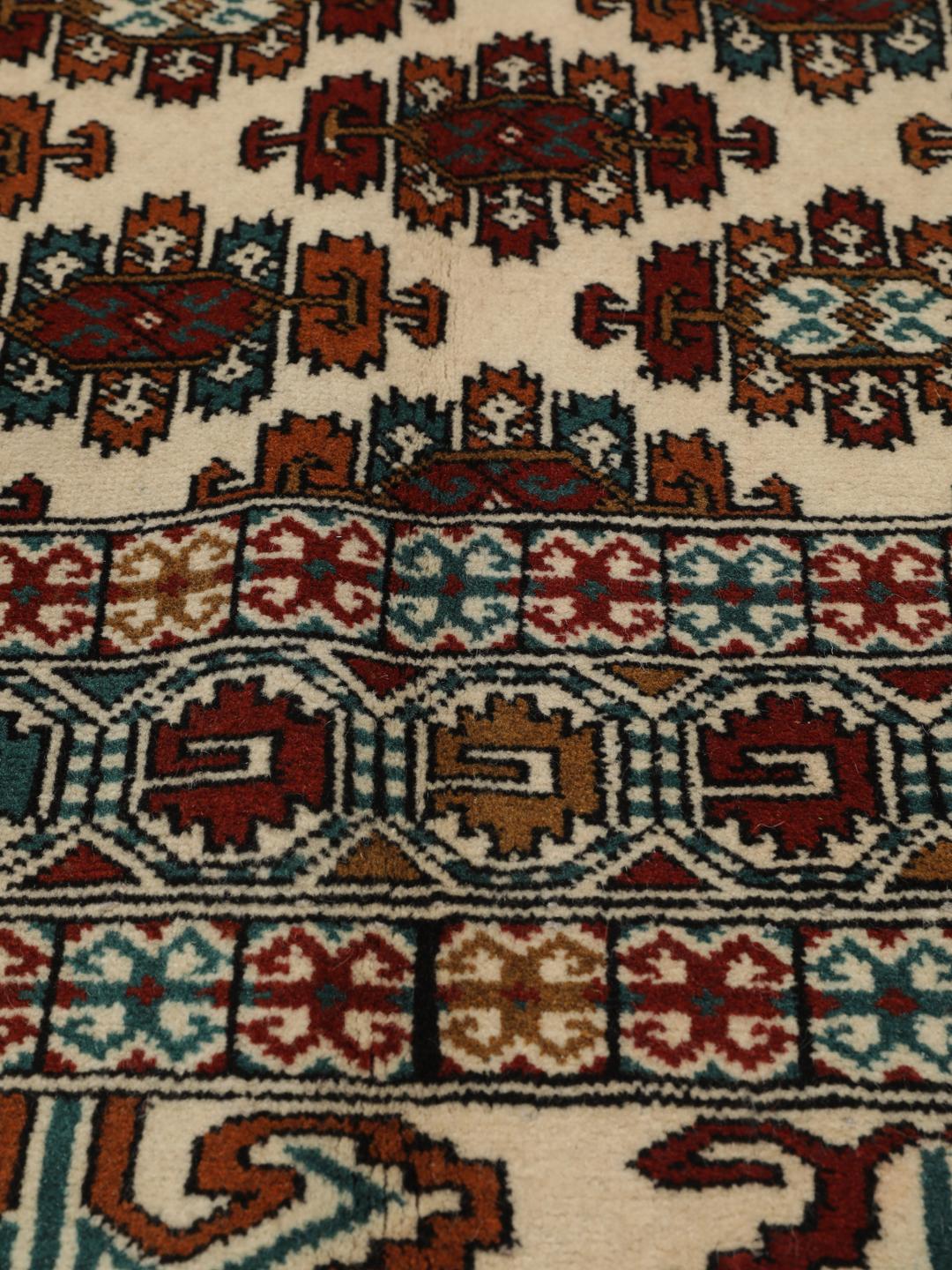 Hand-knotted Turkaman rug from the Middle East in beige with repeating geometric motifs