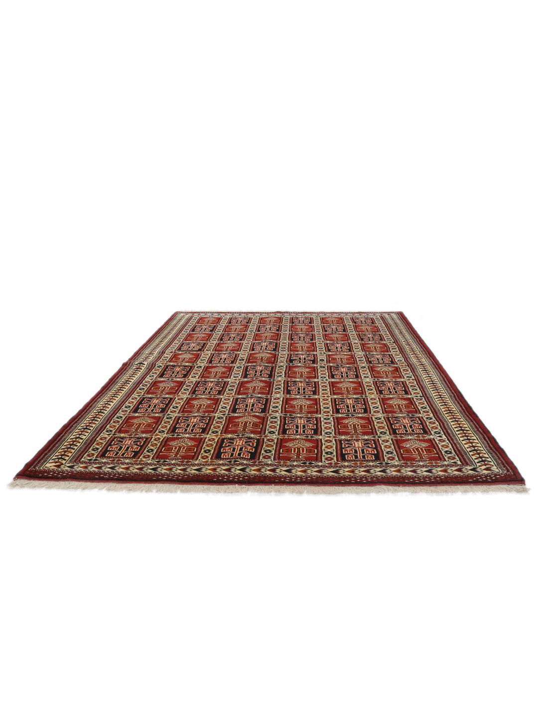 Een handgeknoopt Turkaman-tapijt uit het Midden-Oosten in dieprood met geometrische patronen.