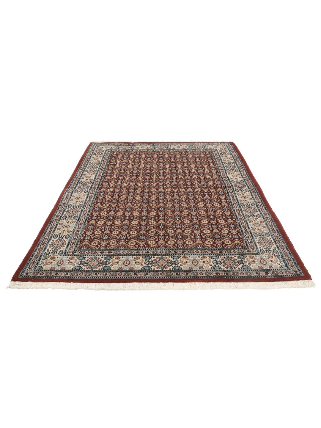 A hand-knotted Moud rug with traditional floral motifs in dark-red and blue tones.