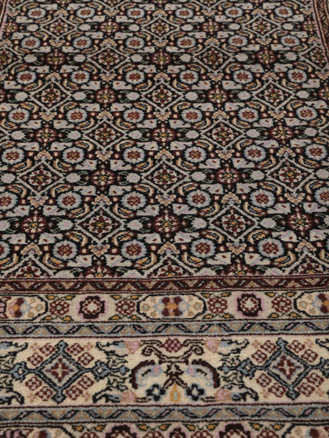 Hand-knotted Moud rug with intricate patterns in multicolor Wool, origin Middle East.