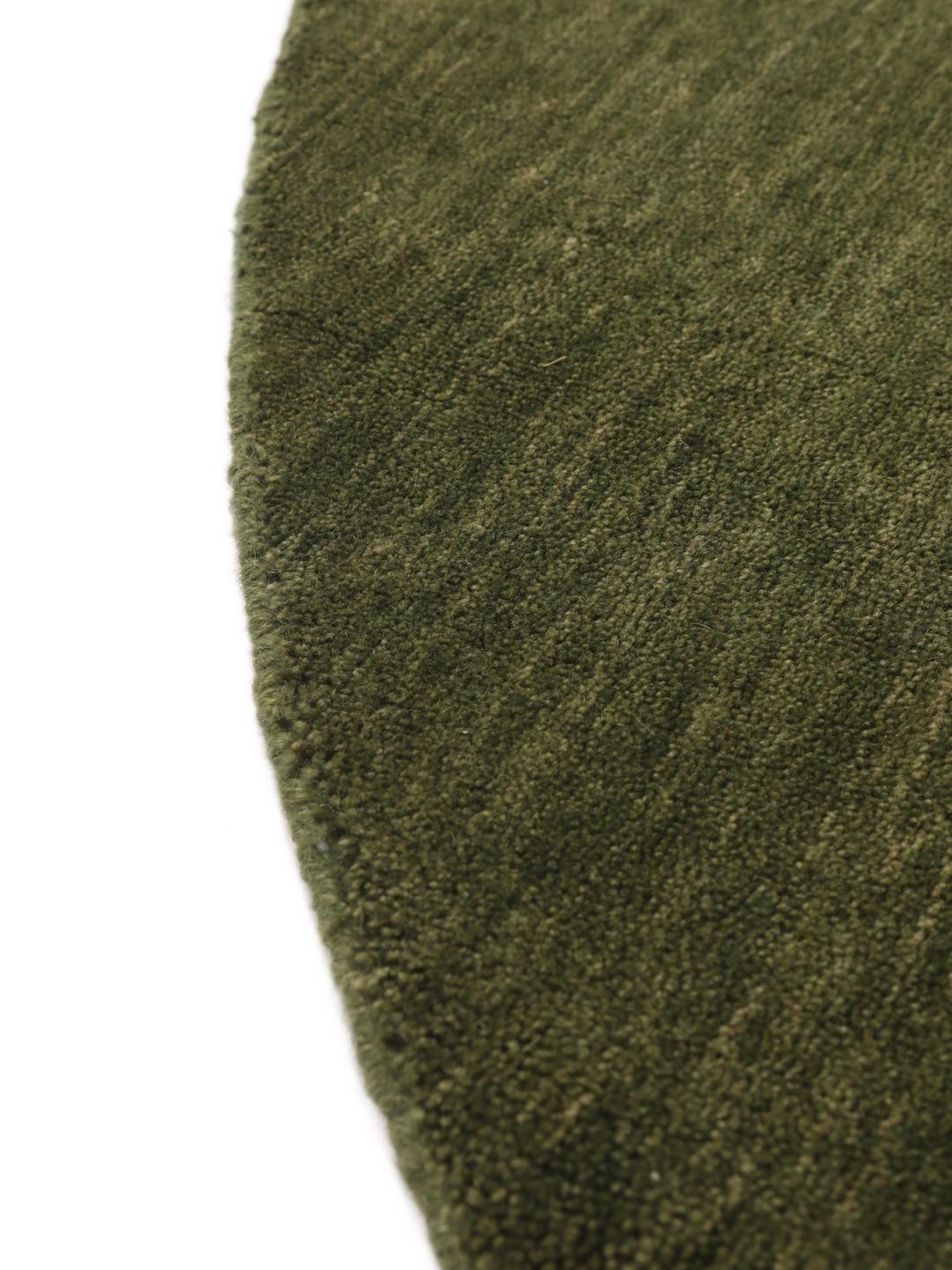 Round green rug in a simple, solid design