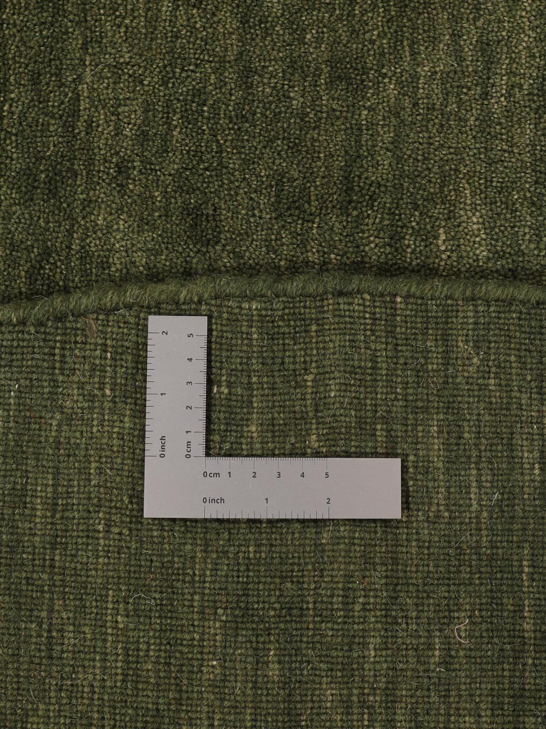 Round green rug in a simple, solid design