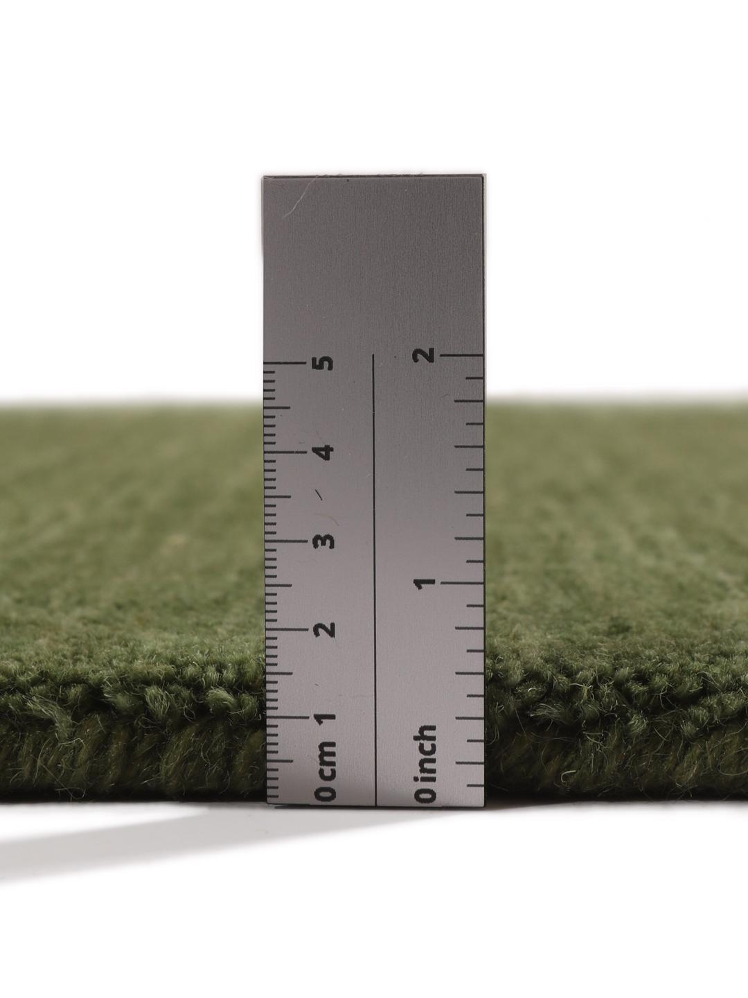 Round green rug in a simple, solid design