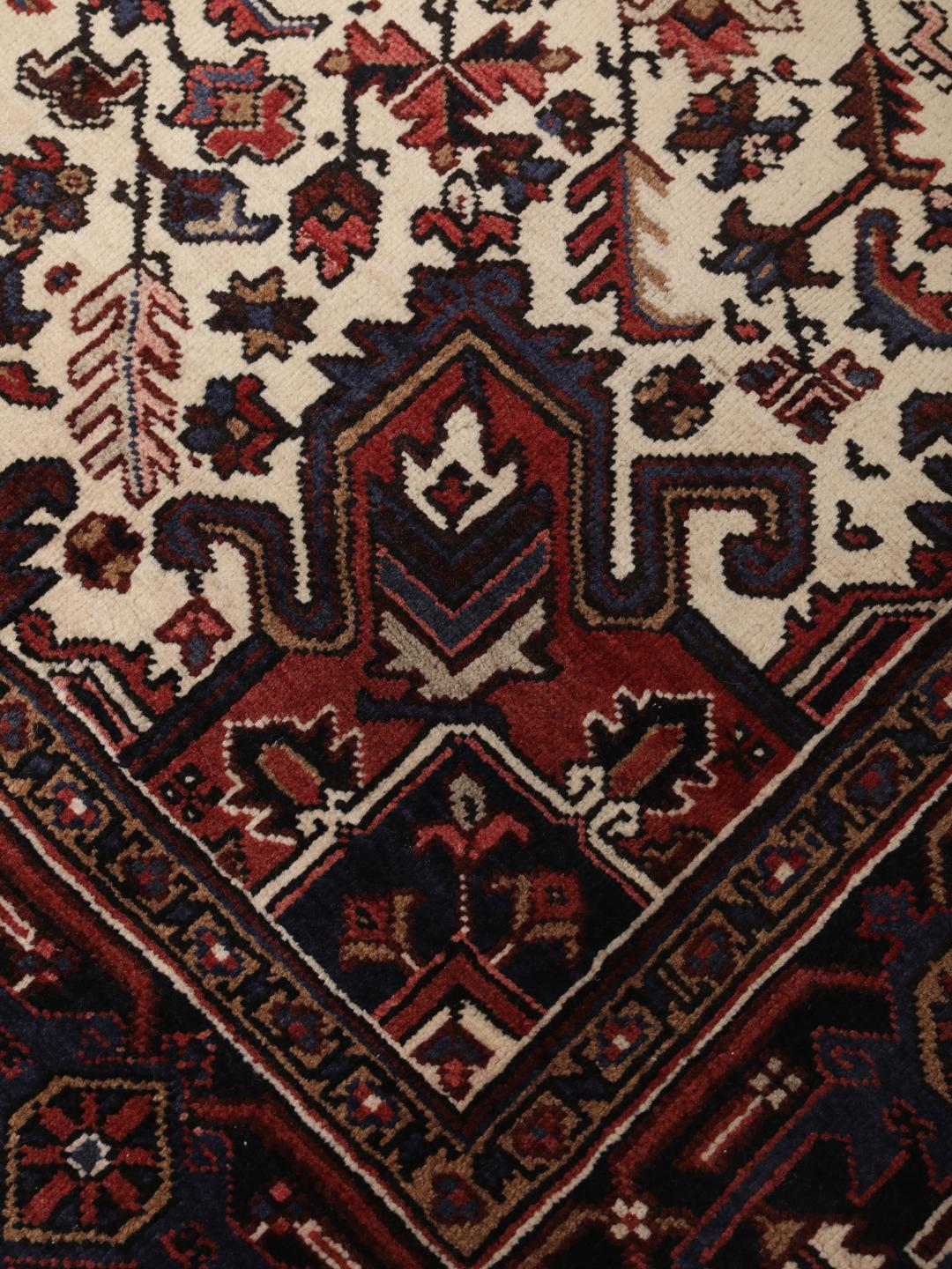 Hand-knotted Heriz rug from the Middle East in red and blue tones