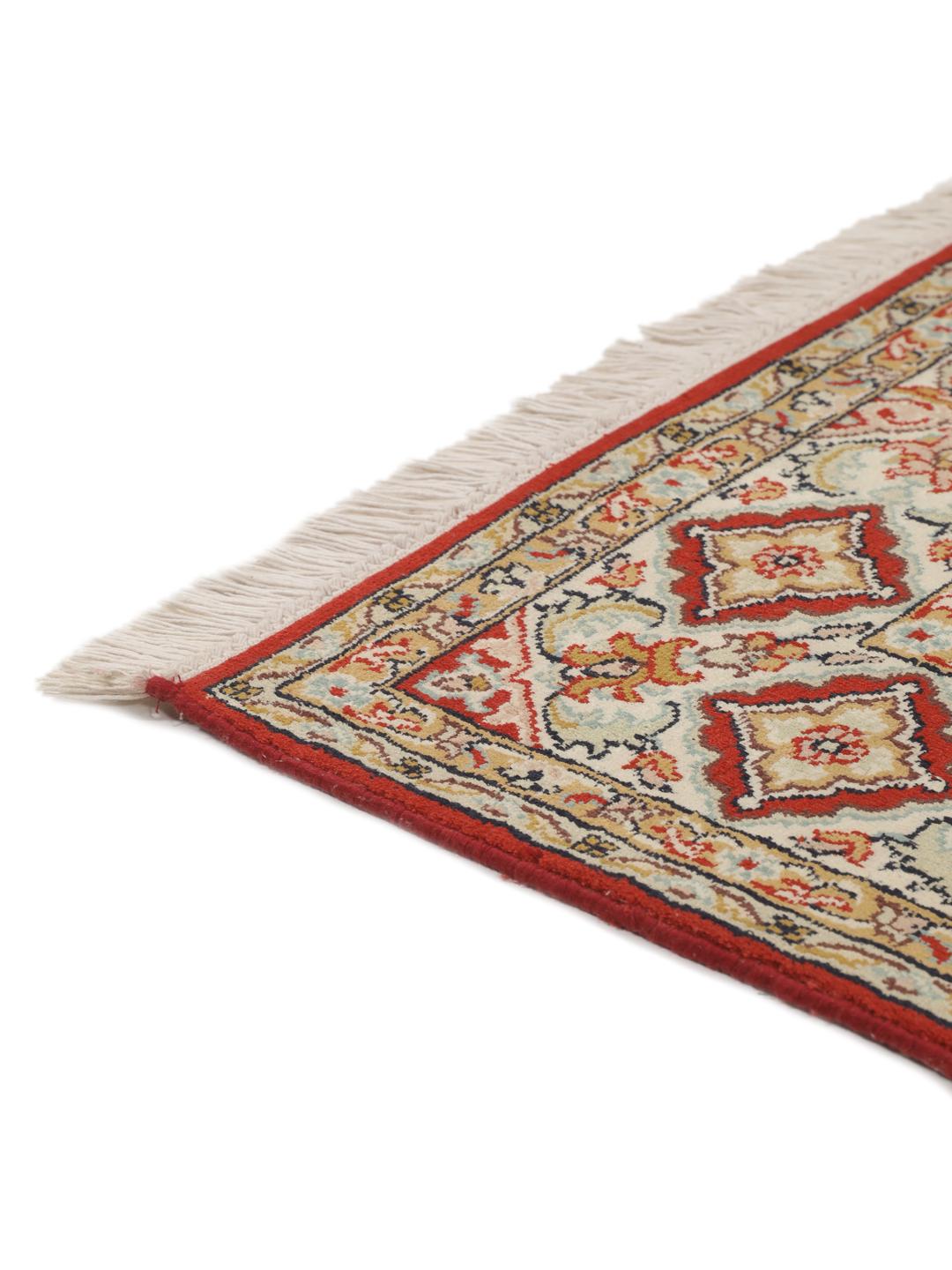 Hand-knotted Kashmir silk rug from India with a vibrant red field and intricate floral motifs.
