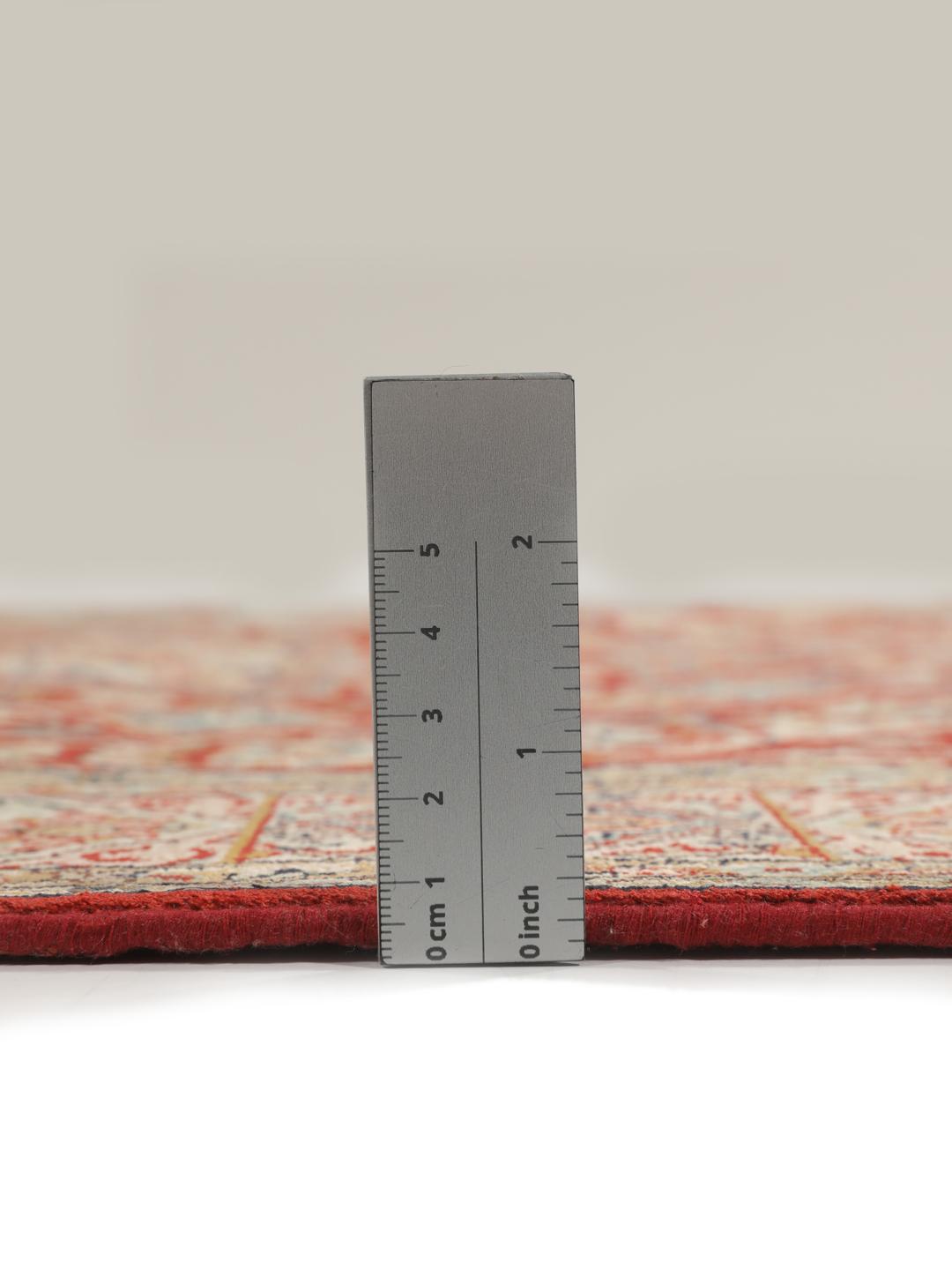Hand-knotted Kashmir silk rug from India with a vibrant red field and intricate floral motifs.