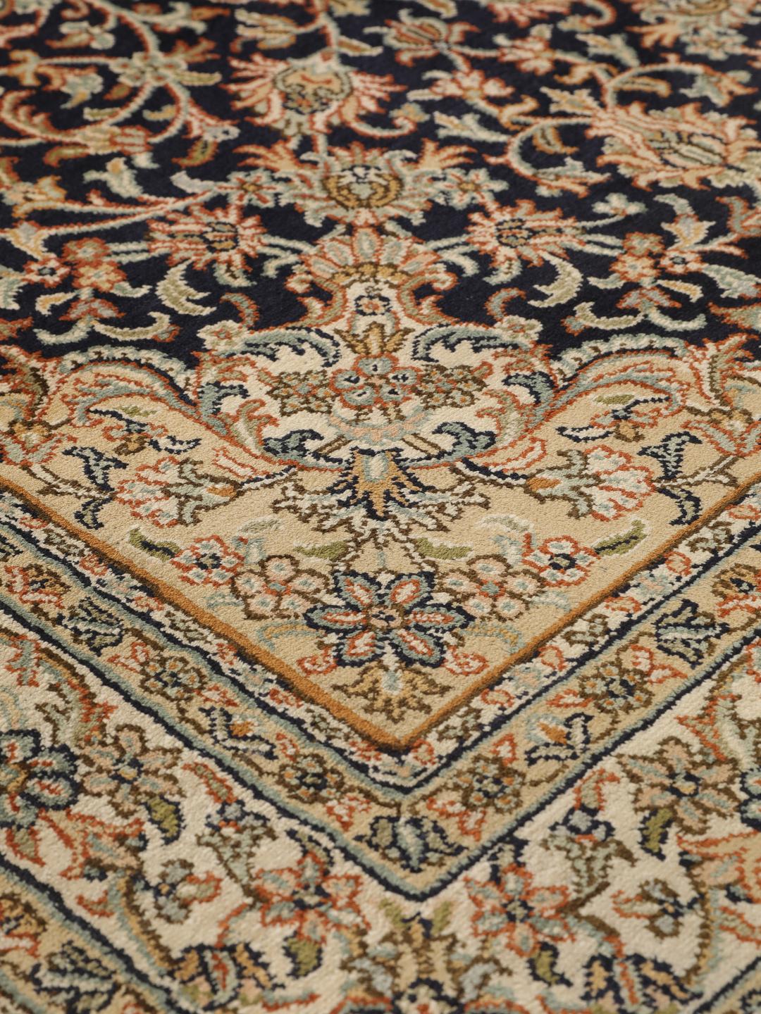 Hand-knotted Indian silk rug with intricate floral medallion patterns in blue and beige.