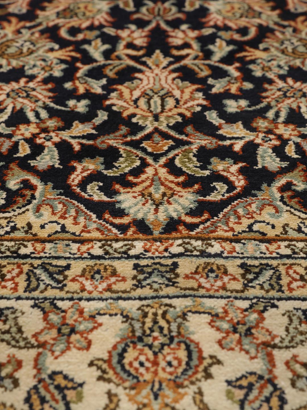 Hand-knotted Indian silk rug with intricate floral medallion patterns in blue and beige.
