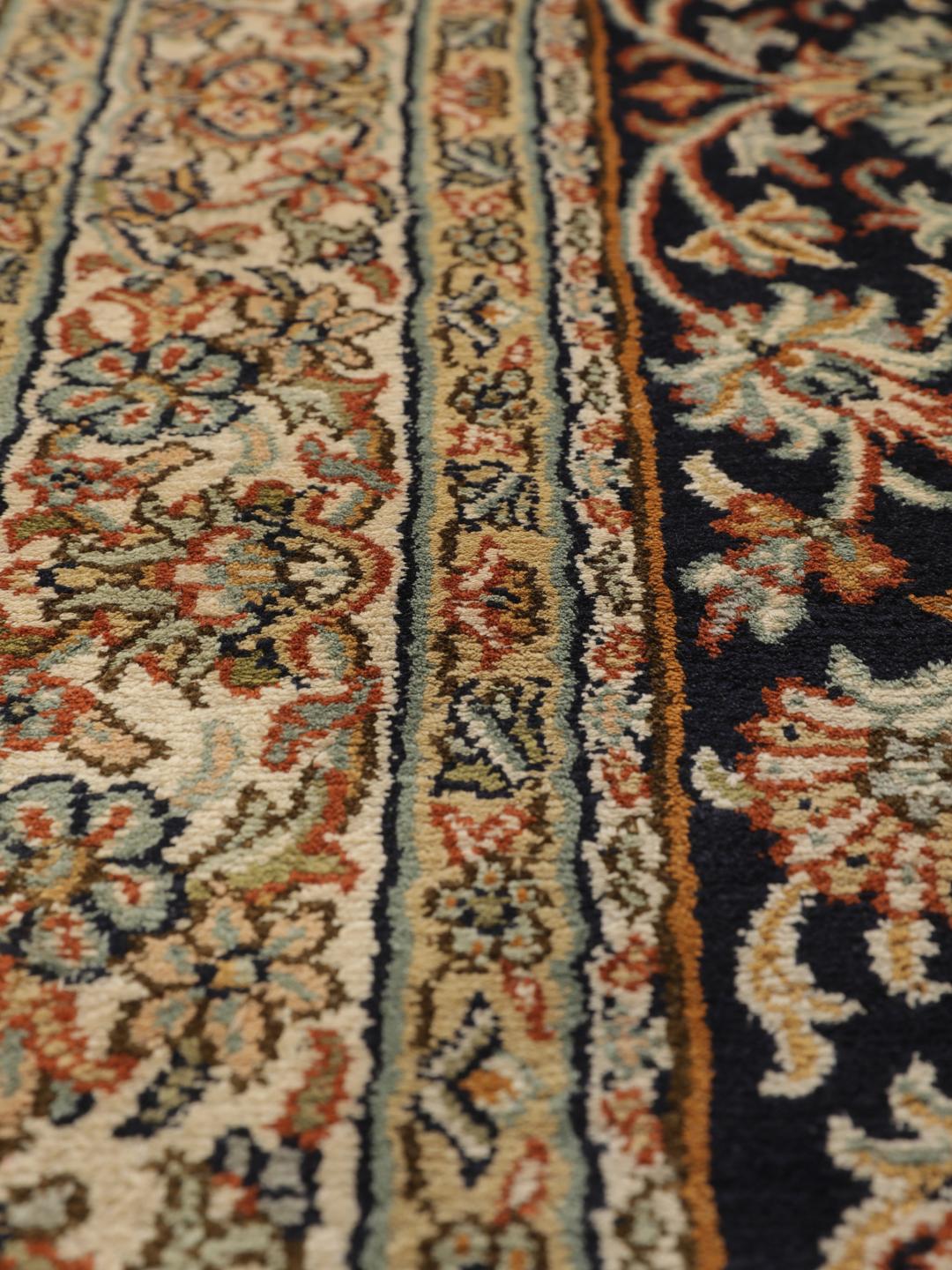 Hand-knotted Indian silk rug with intricate floral medallion patterns in blue and beige.
