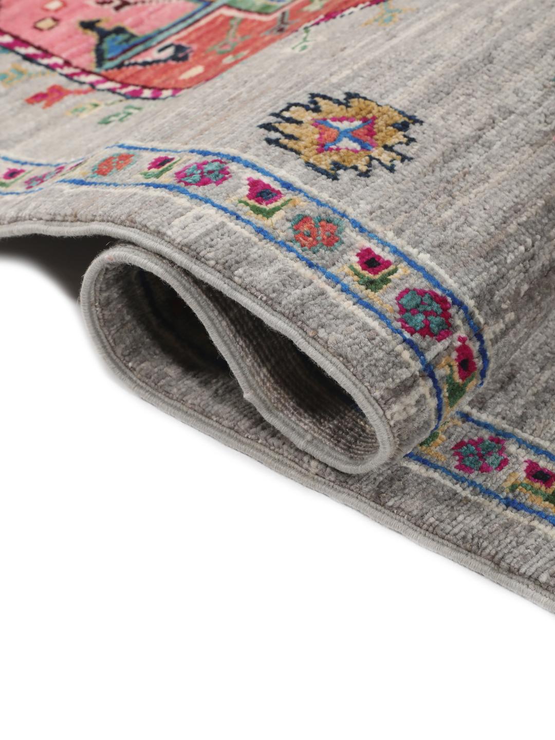 Hand-knotted Afghan rug with vibrant medallion patterns on a grey field