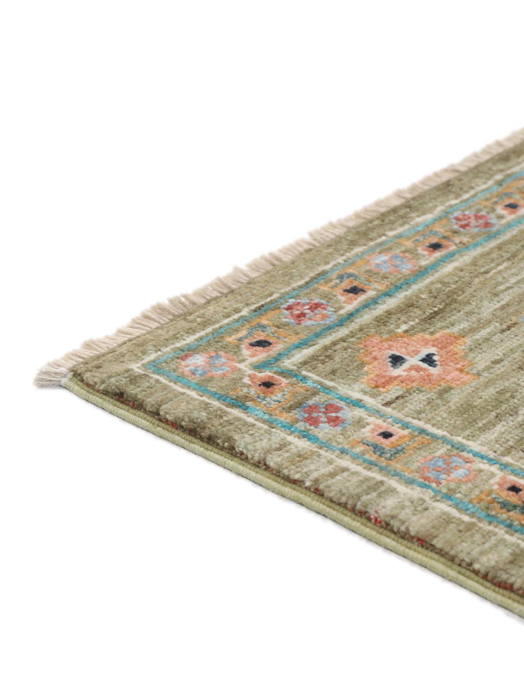 Hand-knotted Afghan rug with olive green field and multi-coloured geometric motifs.