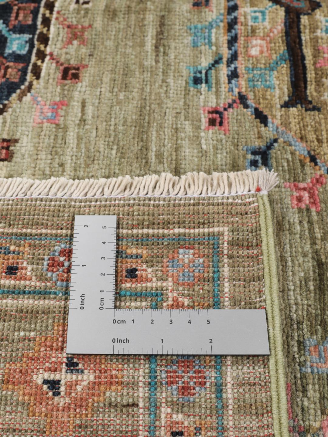 Hand-knotted Afghan rug with olive green field and multi-coloured geometric motifs.