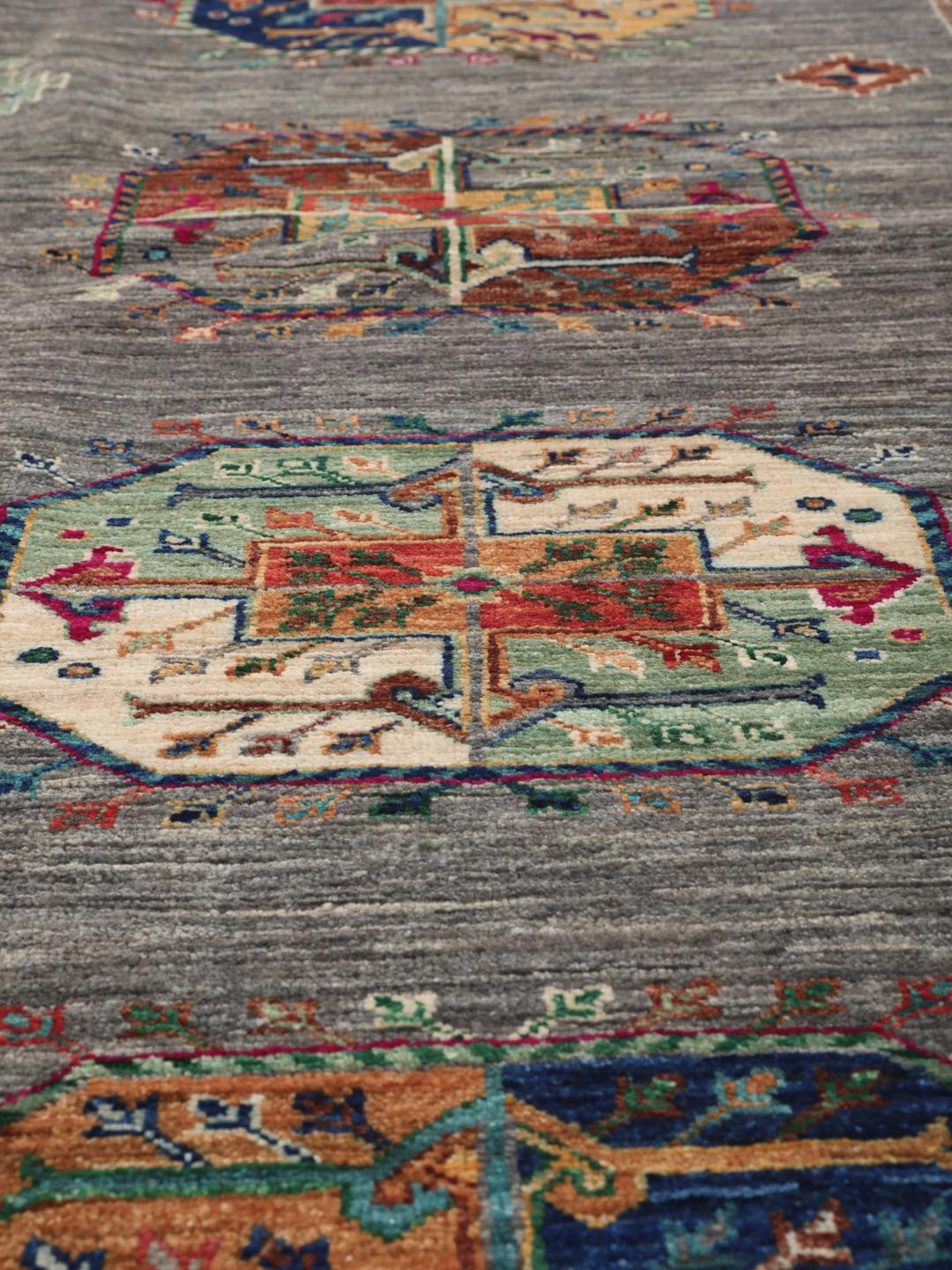 Hand-knotted Shabargan rug from the Middle East in dark-grey with vibrant geometric motifs