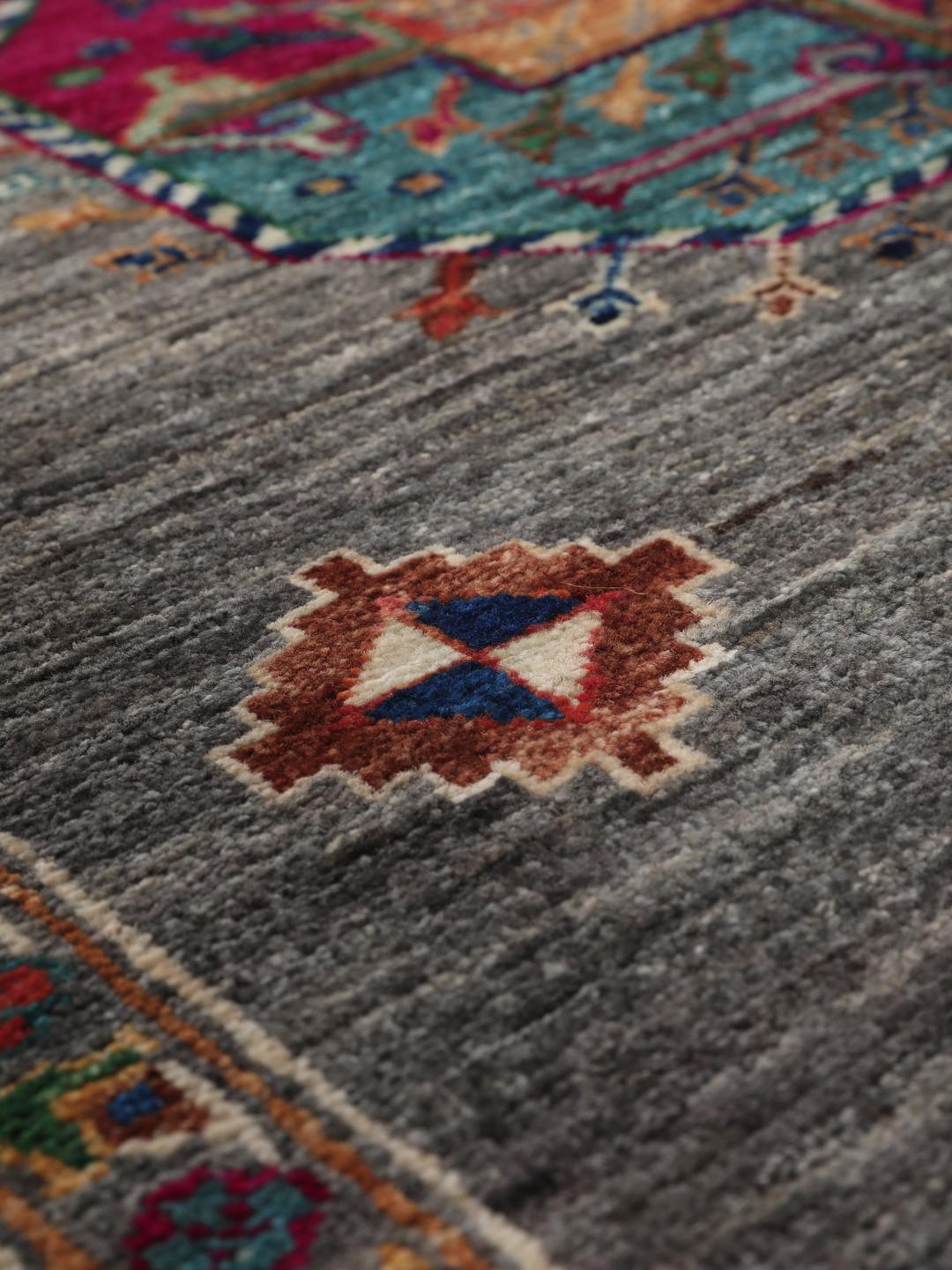Hand-knotted Shabargan rug from the Middle East in dark-grey with vibrant geometric motifs