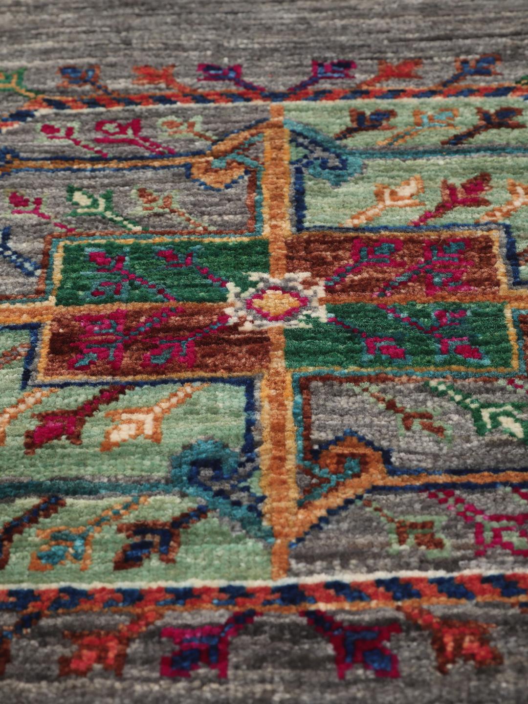 Hand-knotted Shabargan rug from the Middle East in dark-grey with vibrant geometric motifs