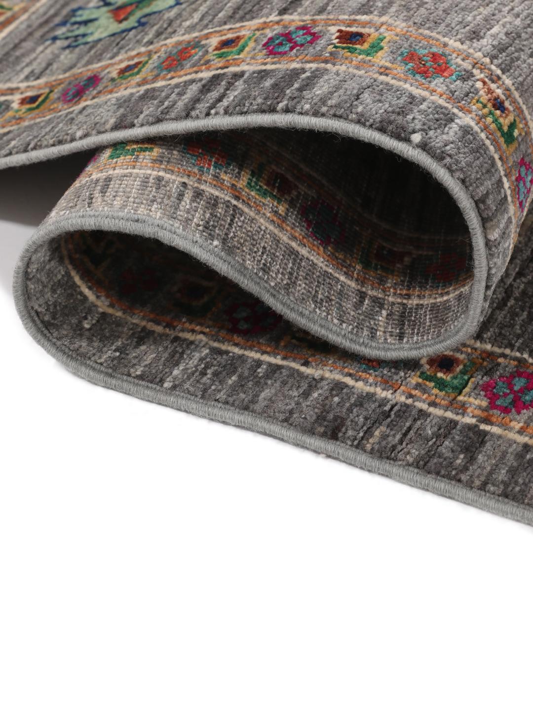 Hand-knotted Shabargan rug from the Middle East in dark-grey with vibrant geometric motifs