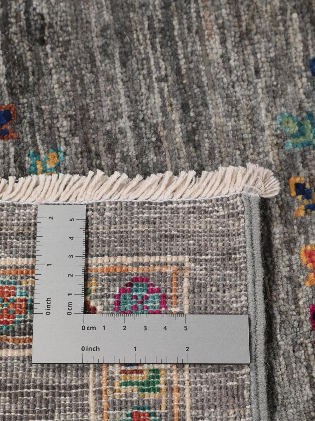 Hand-knotted Shabargan rug from the Middle East in dark-grey with vibrant geometric motifs