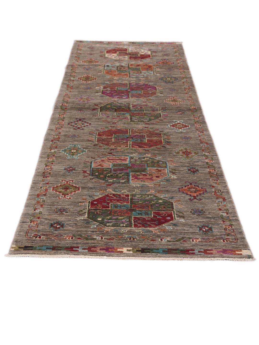 A unique Afghan wool runner featuring colourful geometric motifs on a grey background