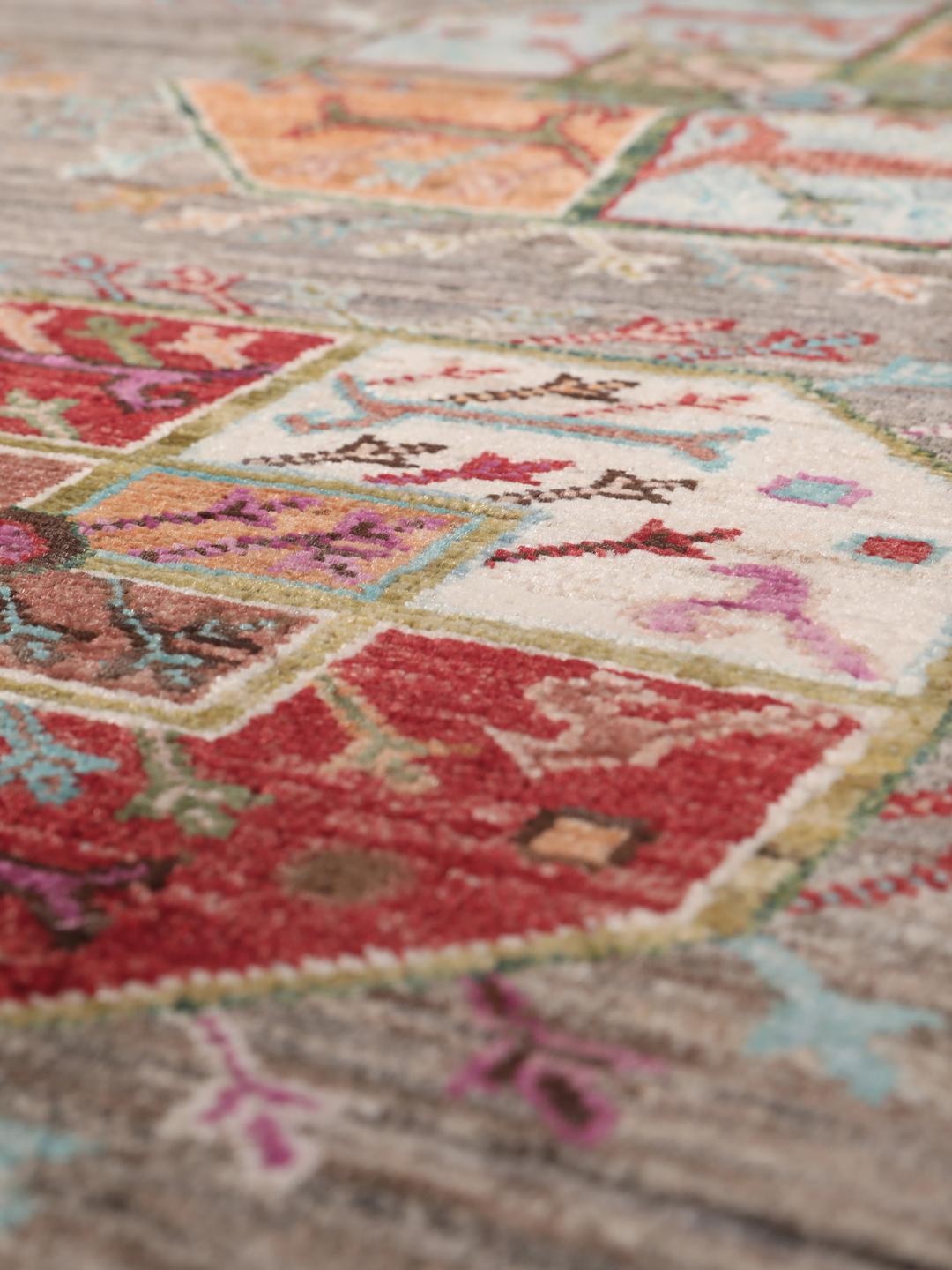 A unique Afghan wool runner featuring colourful geometric motifs on a grey background
