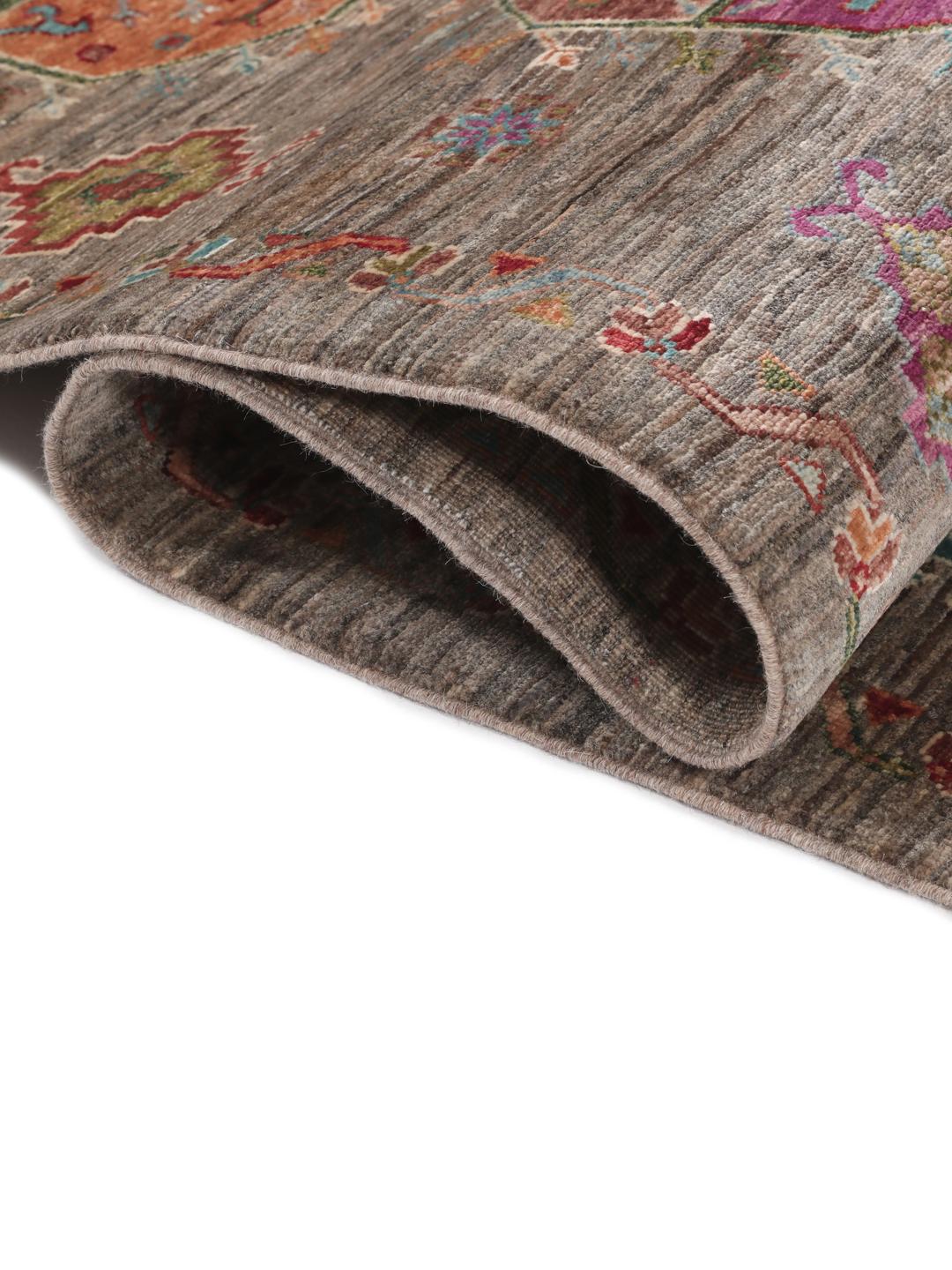 A unique Afghan wool runner featuring colourful geometric motifs on a grey background