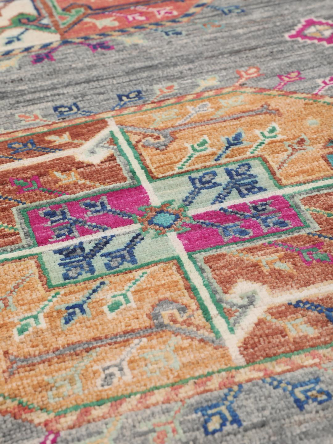 Hand-knotted Afghan rug with a grey field and colourful geometric motifs