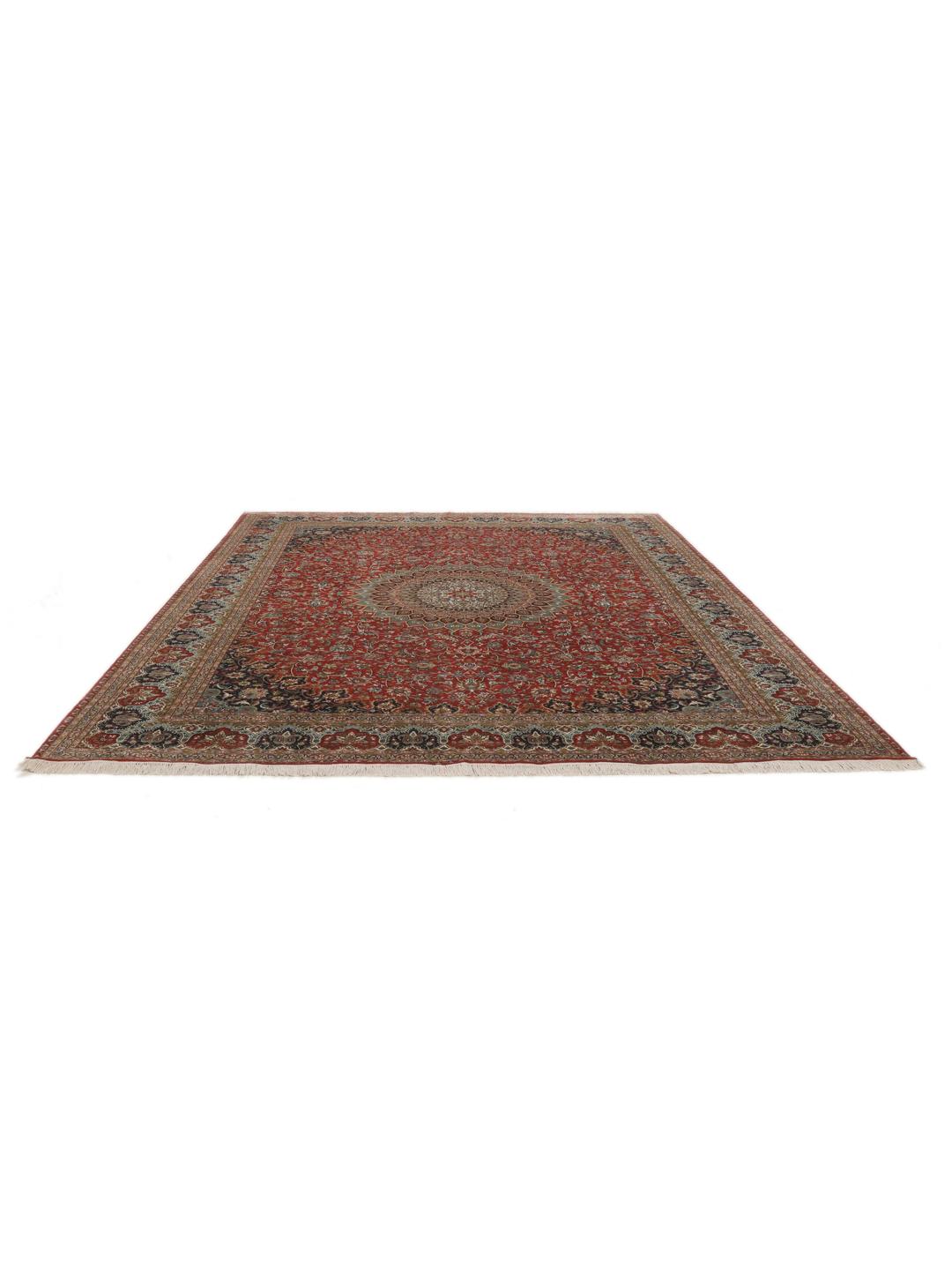 A large rectangular Kashmir silk rug from India with a central medallion on a red field.