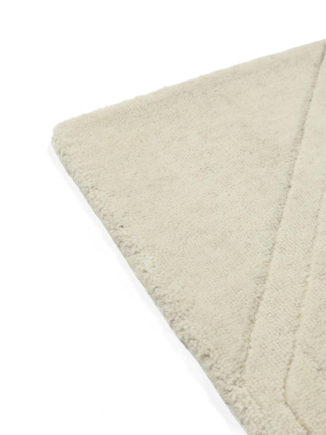 Wit handgeweven wollen tapijt met een subtiel geometrisch patroon