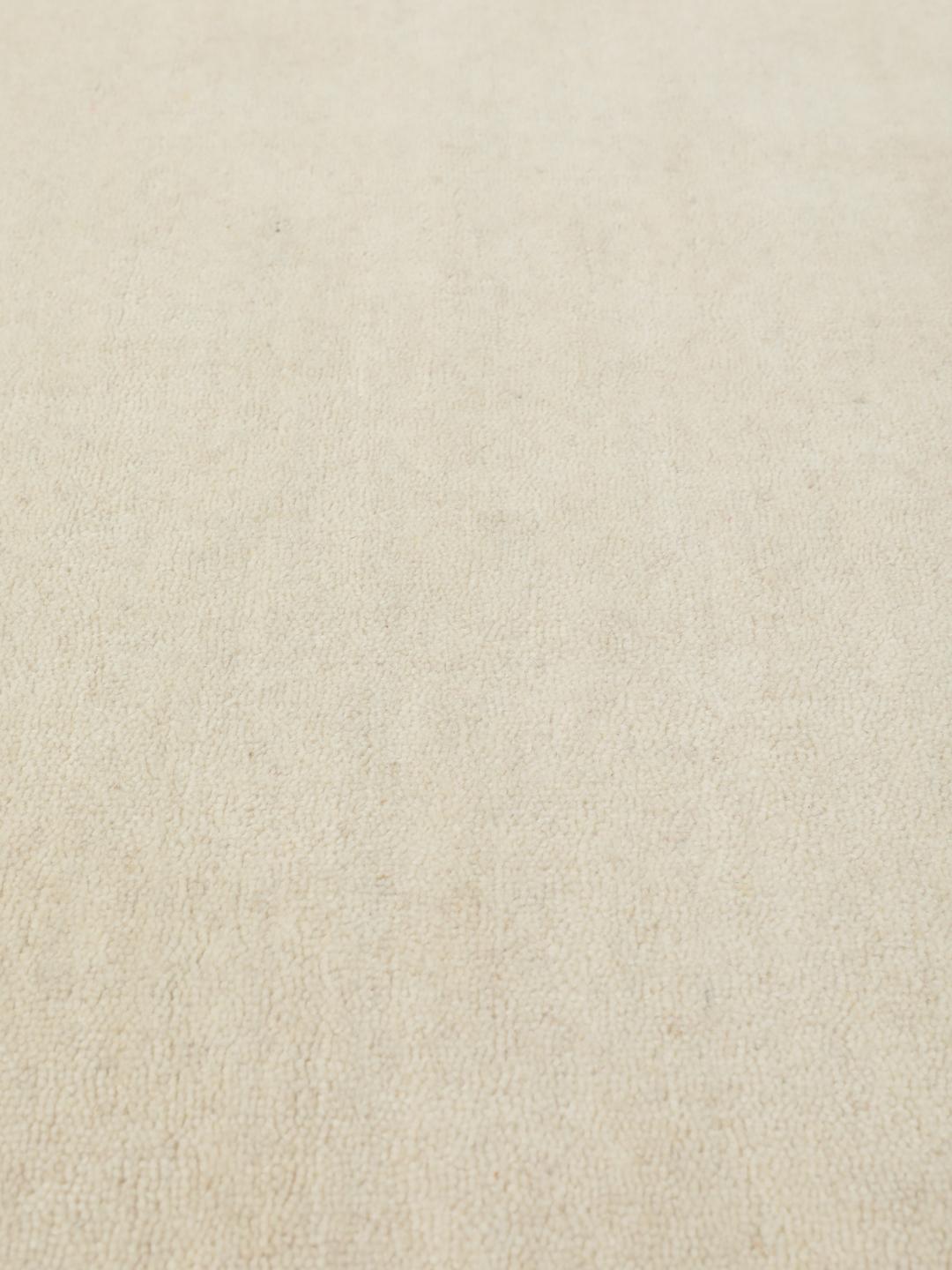 Un tapis rond blanc Handloom fabriqué en laine