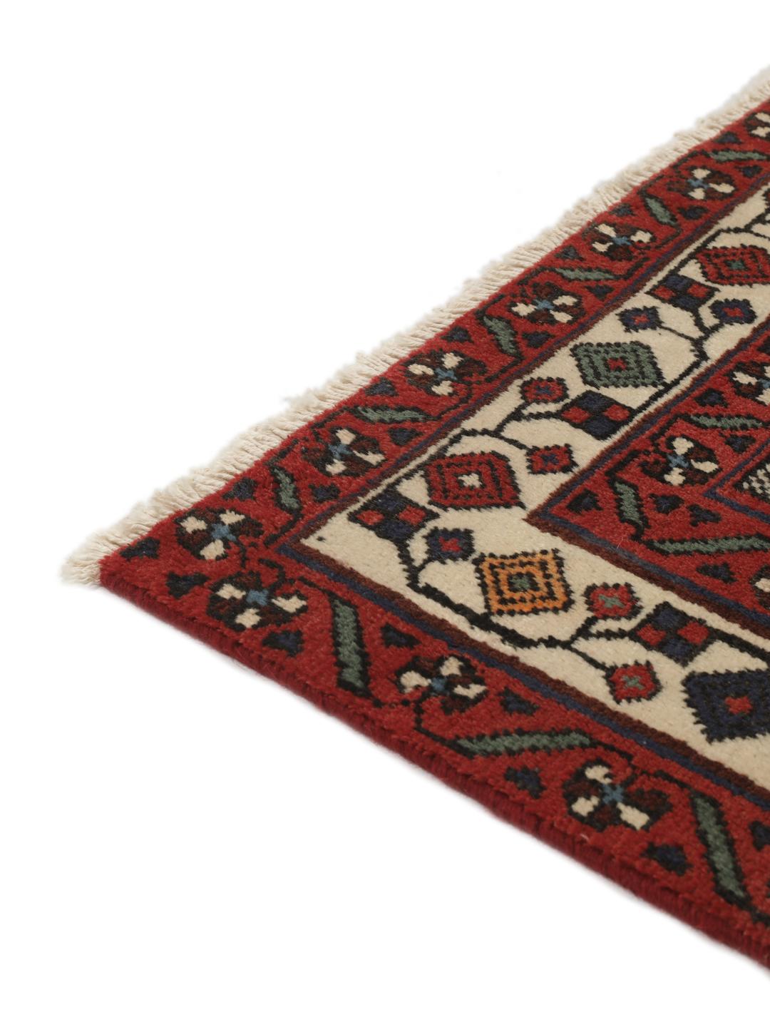 Hand-knotted Afshar wool rug from the Middle East featuring a dark-red and black floral design.