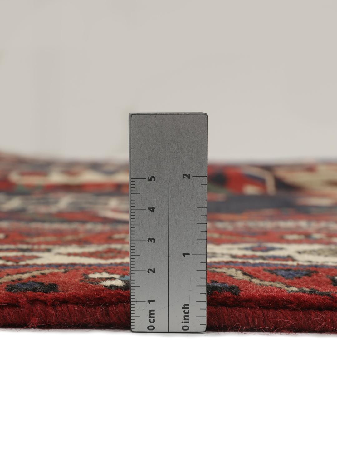 Hand-knotted Afshar wool rug from the Middle East featuring a dark-red and black floral design.