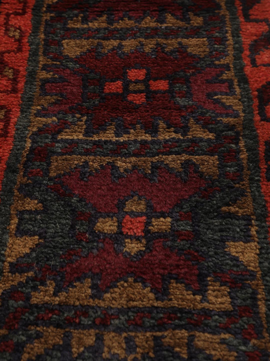 Hand-knotted Lori rug from the Middle East in dark-red and charcoal tones.
