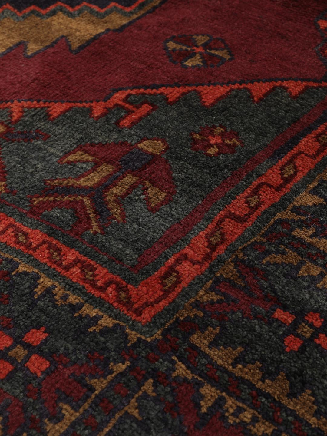 Hand-knotted Lori rug from the Middle East in dark-red and charcoal tones.