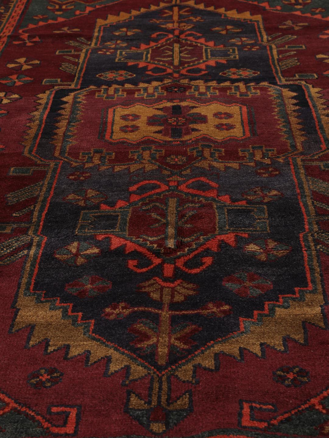 Hand-knotted Lori rug from the Middle East in dark-red and charcoal tones.