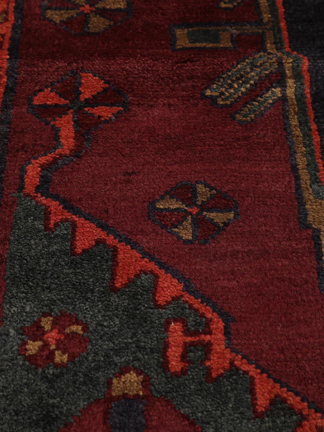 Hand-knotted Lori rug from the Middle East in dark-red and charcoal tones.