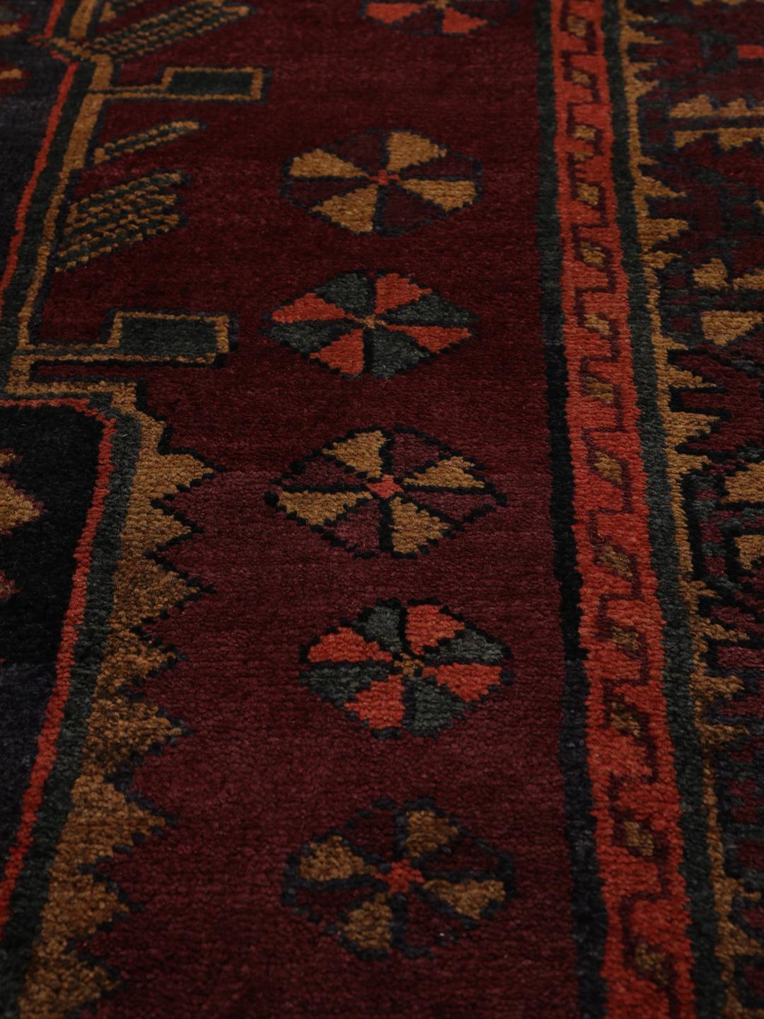 Hand-knotted Lori rug from the Middle East in dark-red and charcoal tones.