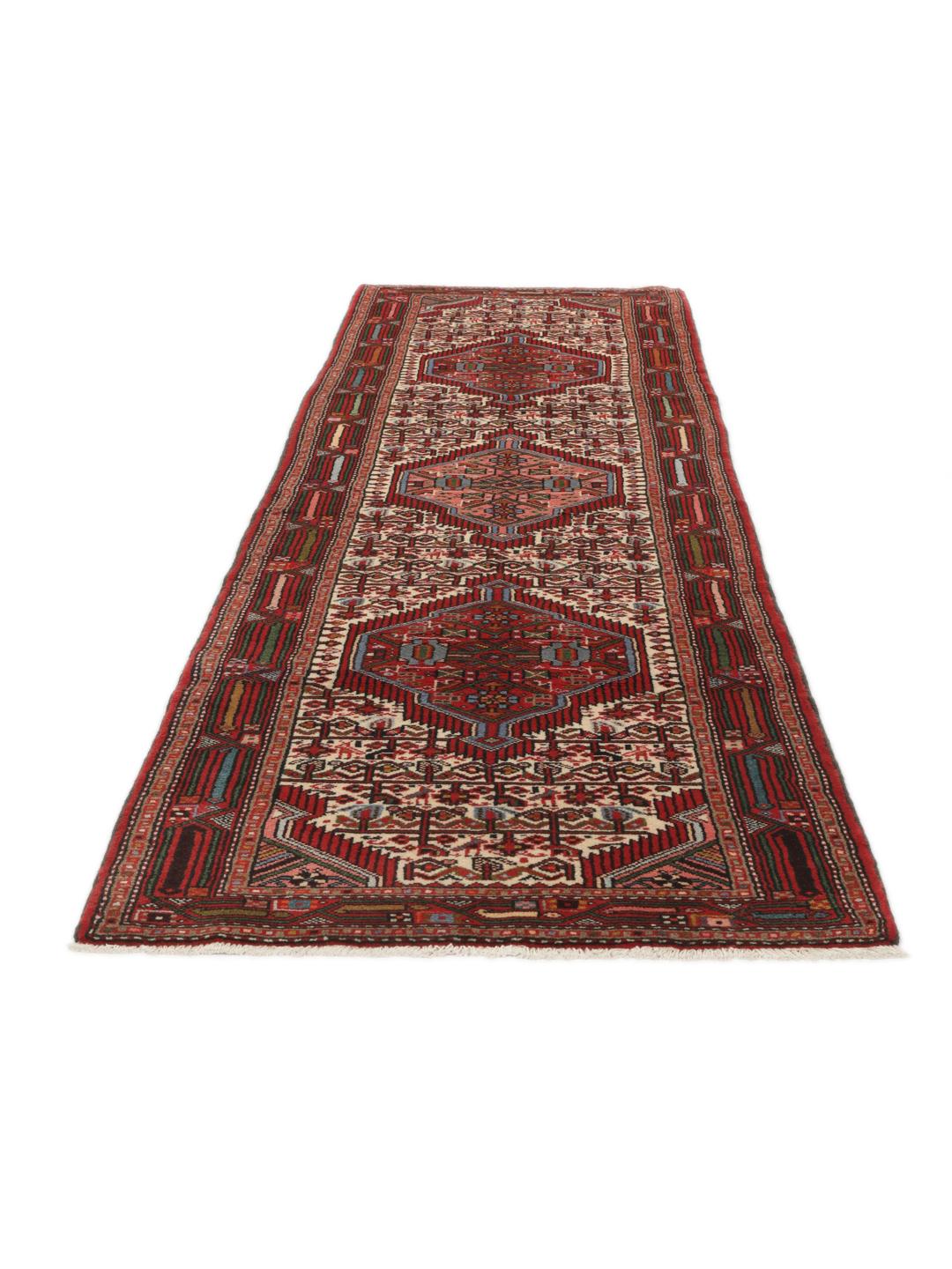 A hand-knotted Hamadan runner with traditional geometric patterns in red and cream.