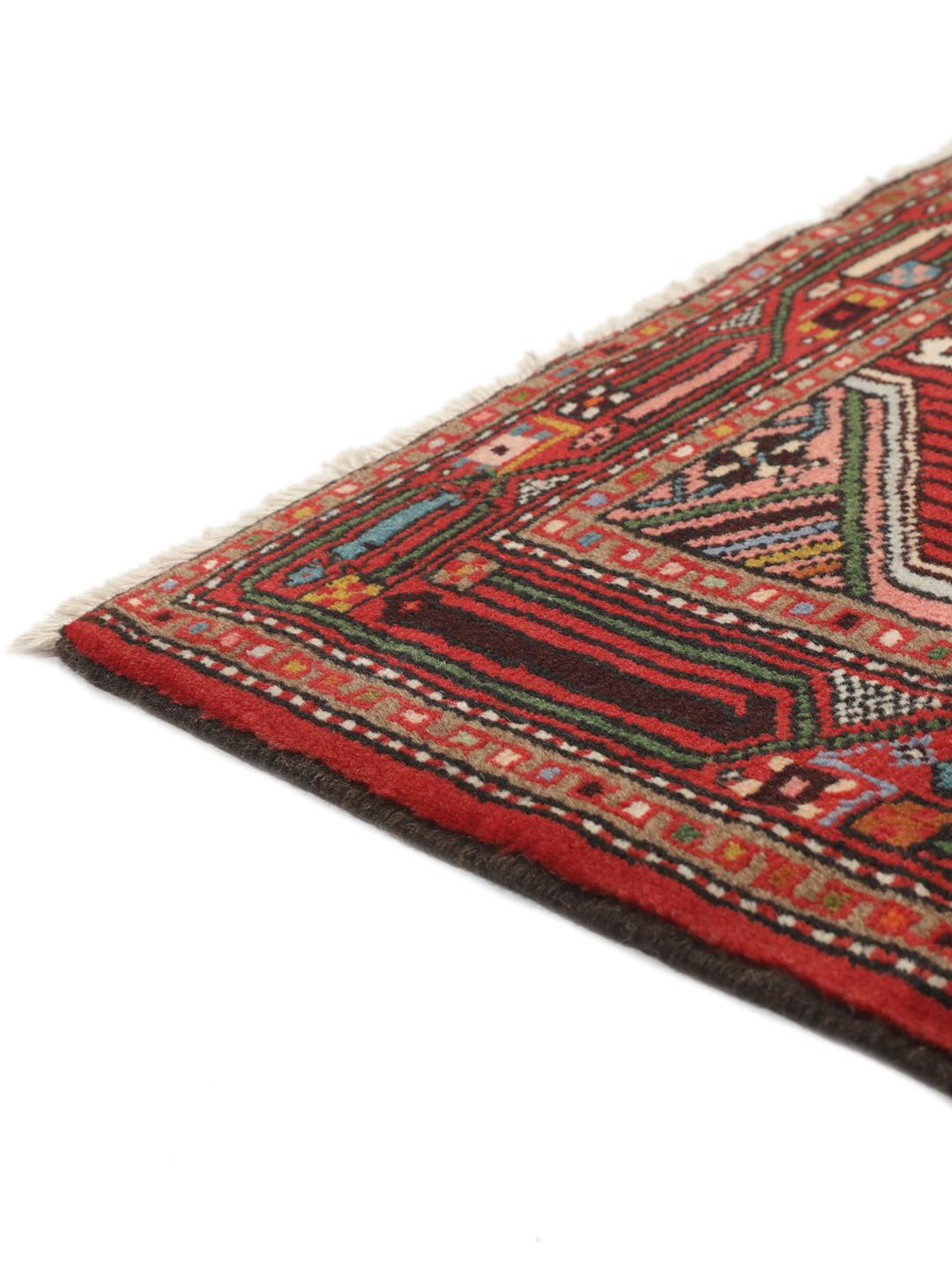A hand-knotted Hamadan runner with traditional geometric patterns in red and cream.