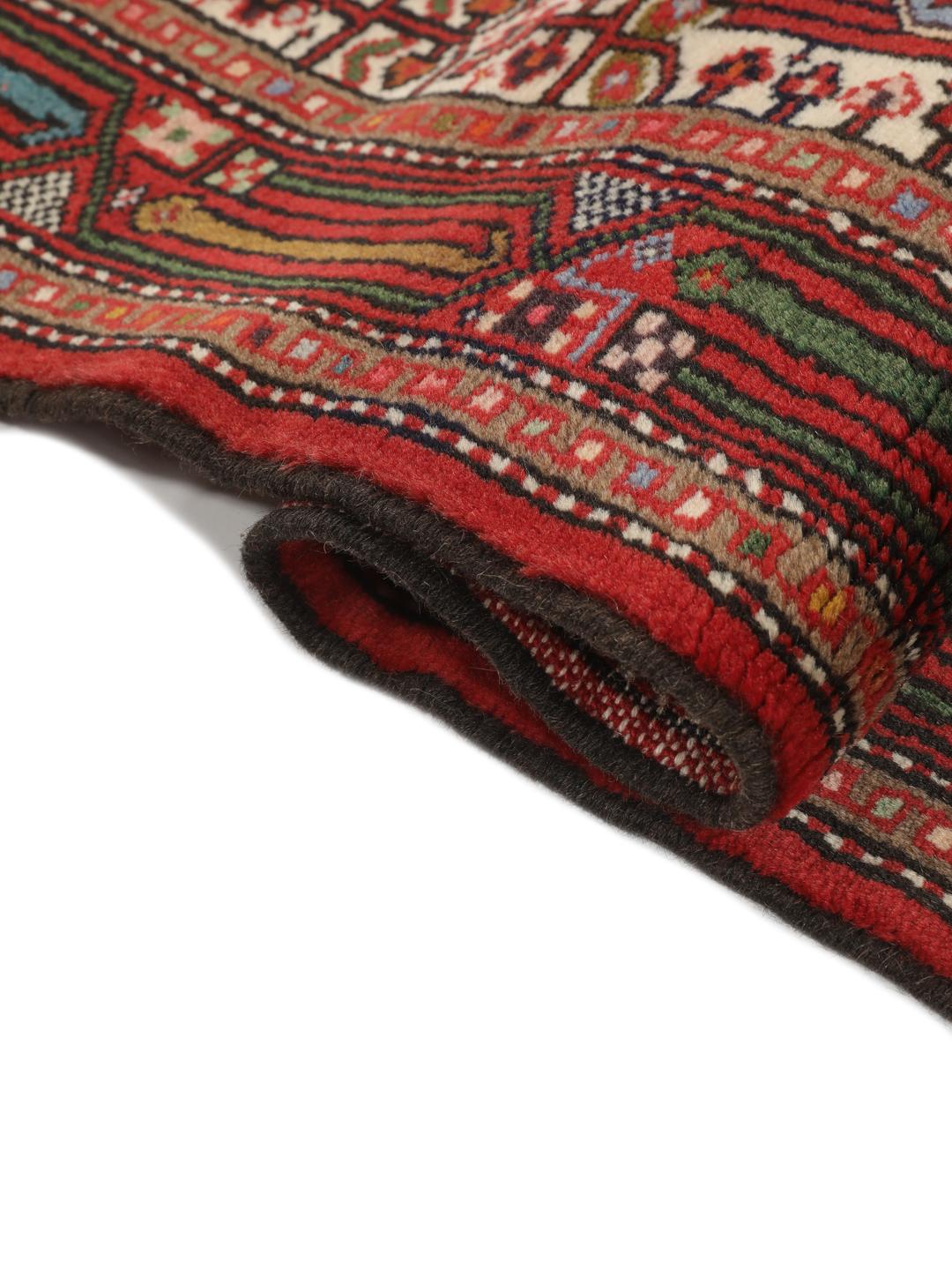A hand-knotted Hamadan runner with traditional geometric patterns in red and cream.